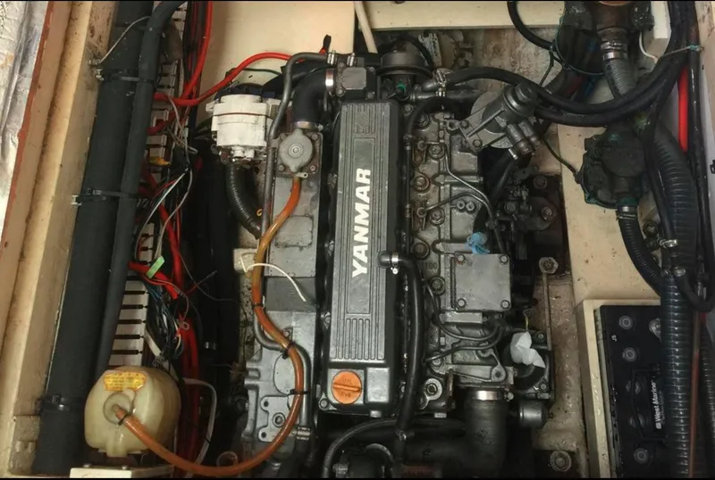 Slide: The Image of Yanmar engine in a 1990 Irwin 54 sailboat, showcasing detailed components and wiring. - 48