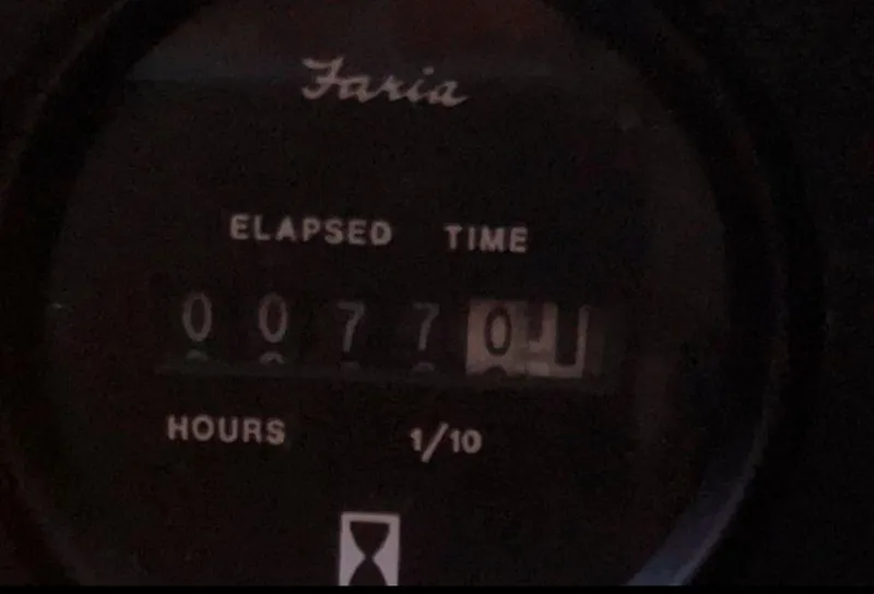 Slide: The Image of Faria elapsed time meter showing 77.0 hours on Irwin 54, 1990 model. - 49