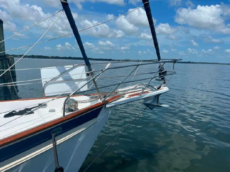 Slide: The Image of Irwin 54 sailboat from 1990 on calm water under a blue sky. - 9