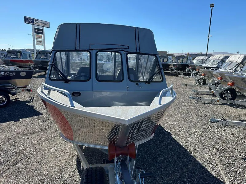 Slide: The Image of 2025 Hewescraft 200 Sportsman boat displayed in a dealership lot. - 2