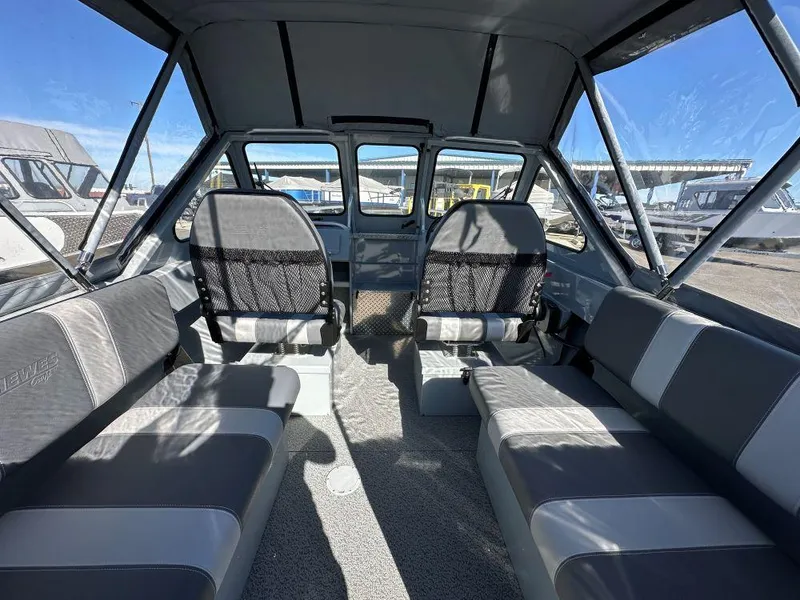 Slide: The Image of 2025 Hewescraft 200 Sportsman boat interior with seating and windows. - 5