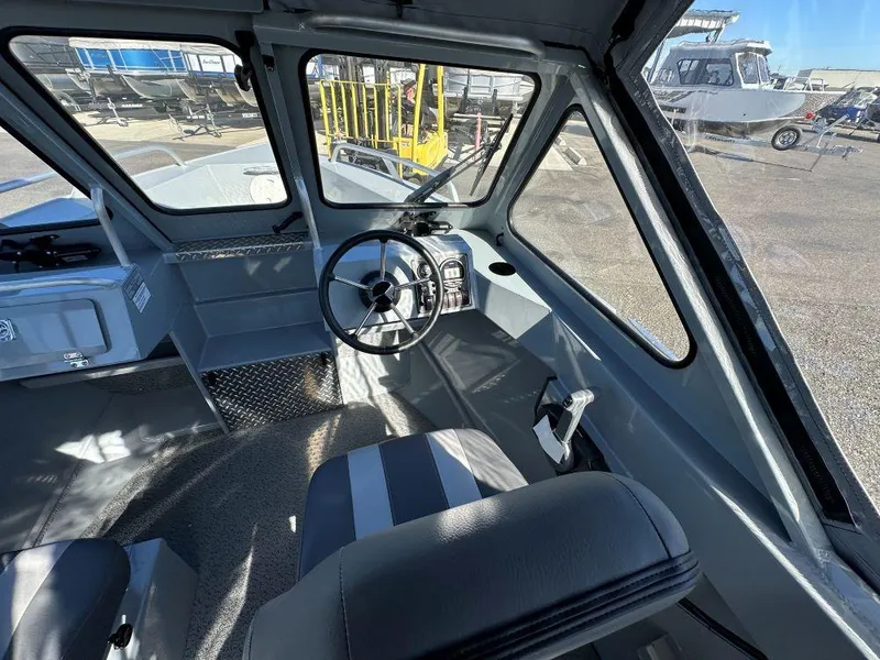 Slide: The Image of 2025 Hewescraft 200 Sportsman boat interior with steering wheel and seating. - 6