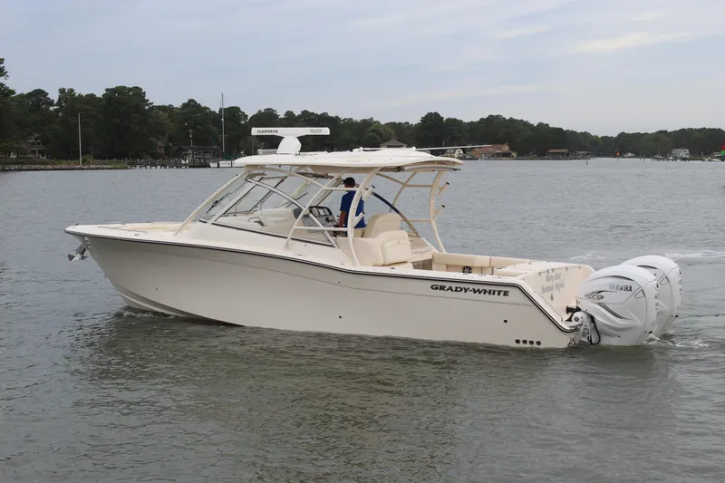 Slide: The Image of 2023 Grady-White Freedom 335 boat with Yamaha outboard motor, docked by the water. - 3