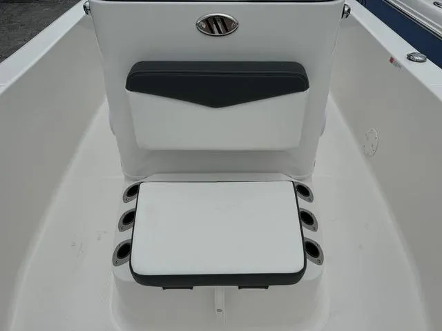Slide: The Image of 2025 Robalo R160CC boat seating with integrated rod holders. - 11
