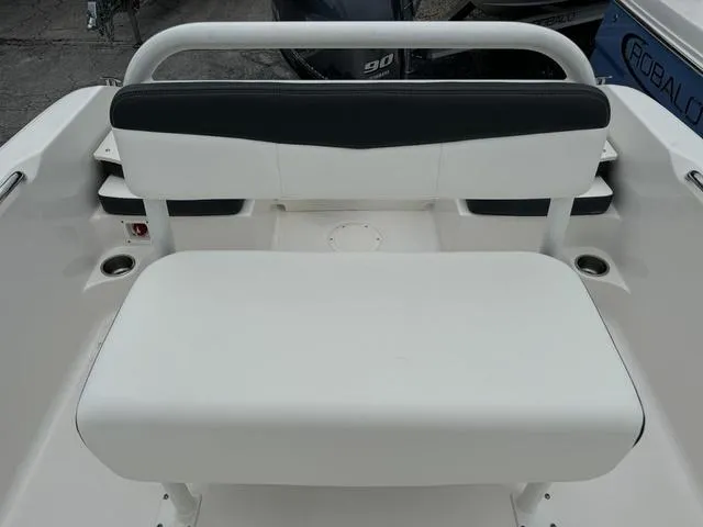 Slide: The Image of 2025 Robalo R160CC boat seating area with white and black upholstery. - 13