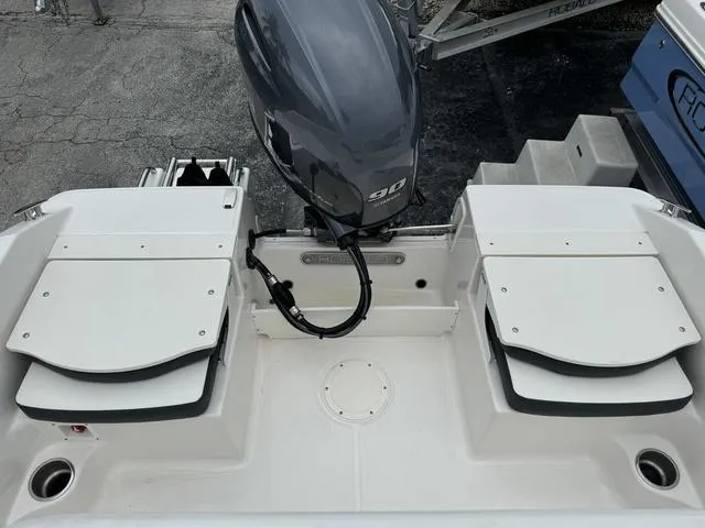 Slide: The Image of 2025 Robalo R160CC boat with 90 HP outboard motor, rear seating view. - 14
