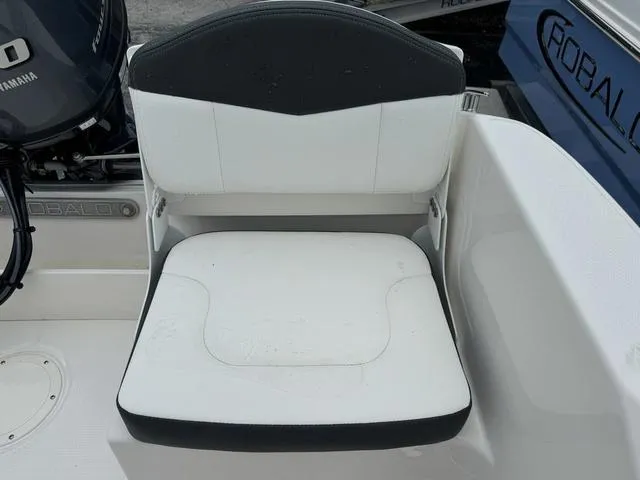 Slide: The Image of 2025 Robalo R160CC boat seat with Yamaha engine in background. - 15