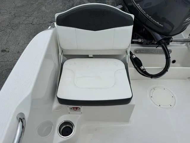 Slide: The Image of Robalo R160CC 2025 boat seat with black and white upholstery, cup holder, and motor detail. - 16