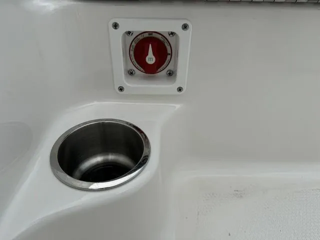 Slide: The Image of Robalo R160CC 2025 boat detail with cup holder and control switch. - 17