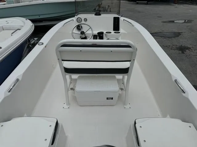 Slide: The Image of 2025 Robalo R160CC boat interior with steering console and seating. - 4