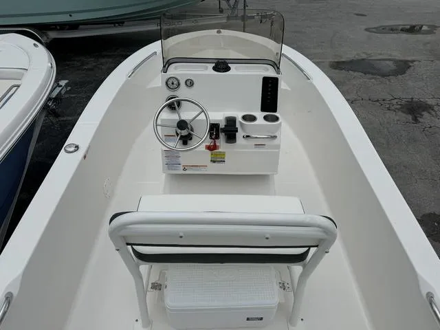 Slide: The Image of 2025 Robalo R160CC boat interior with steering console and seating. - 5