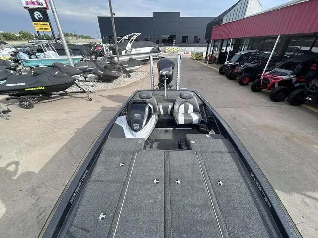 Slide: The Image of 2018 Skeeter ZX250 boat displayed at dealership with other vehicles. - 16