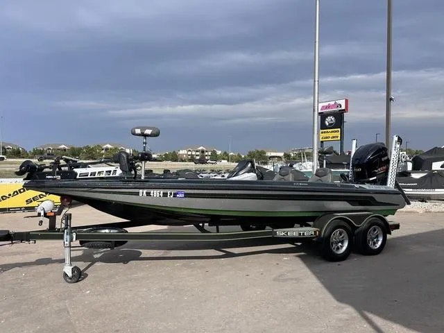Slide: The Image of 2018 Skeeter ZX250 bass boat on trailer in outdoor setting. - 2