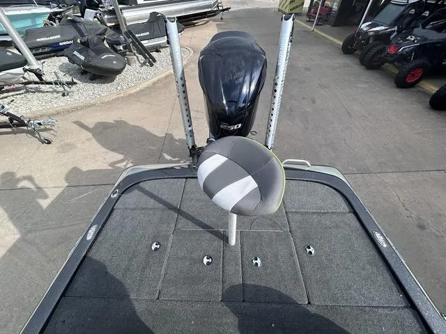 Slide: The Image of 2018 Skeeter ZX250 boat deck with motor and seat, parked outdoors. - 20