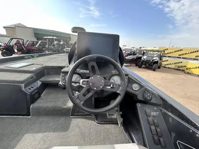 Slide: The Image of 2018 Skeeter ZX250 boat dashboard with steering wheel and control panel. - 23