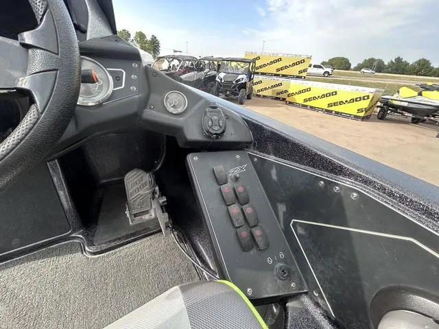 Slide: The Image of 2018 Skeeter ZX250 boat dashboard with controls and steering wheel. - 24