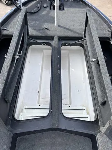 Slide: The Image of 2018 Skeeter ZX250 boat storage compartments, open and empty, showcasing interior space. - 34