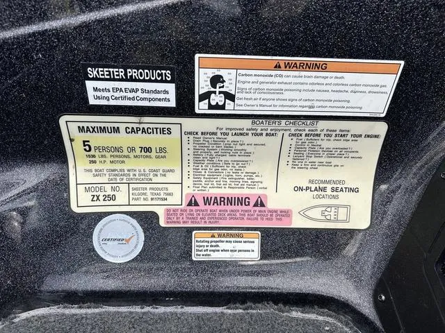Slide: The Image of Warning labels and capacity information on a 2018 Skeeter ZX250 boat. - 38