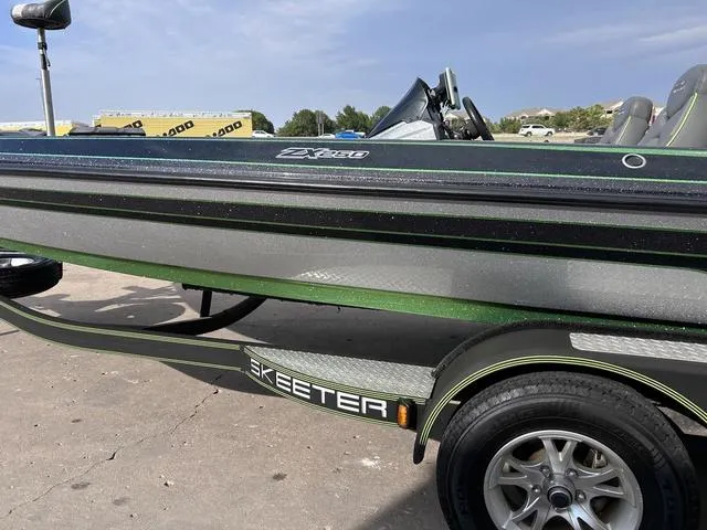 Slide: The Image of 2018 Skeeter ZX250 boat on trailer, side view with green and black accents. - 4