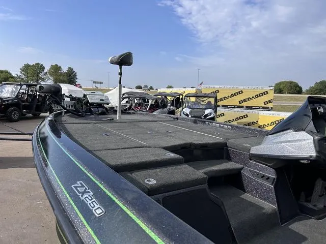 Slide: The Image of 2018 Skeeter ZX250 boat on display, surrounded by other vehicles and Sea-Doo banners. - 7