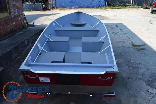 Slide: The Image of 2025 Lund SSV-16 Tiller boat, red and gray, parked outdoors. - 10