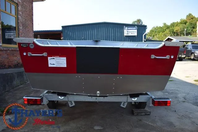 Slide: The Image of 2025 Lund SSV-16 Tiller boat on trailer, rear view, red and silver design. - 11