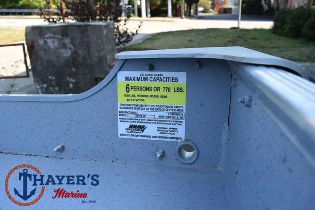 Slide: The Image of Lund SSV-16 Tiller 2025 boat capacity label, 6 persons or 770 lbs, Thayer's Marine logo. - 14