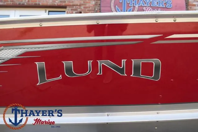 Slide: The Image of Red 2025 Lund SSV-16 Tiller boat with Thayer's Marine logo. - 4