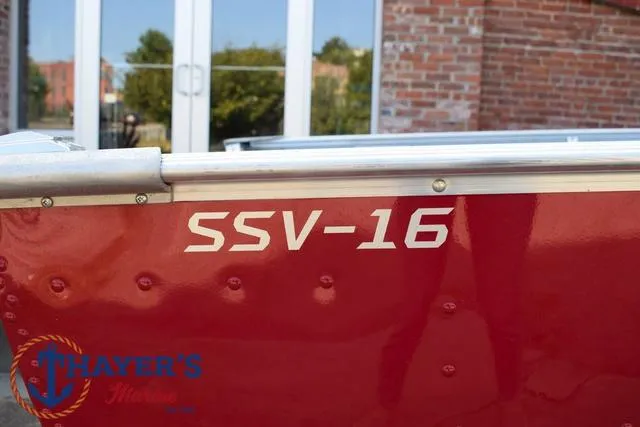 Slide: The Image of 2025 Lund SSV-16 Tiller boat, red exterior, close-up view. - 5