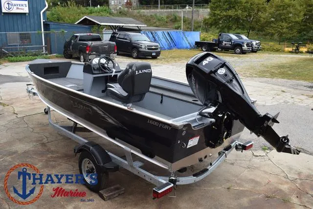 Slide: The Image of 2025 Lund 1600 Fury SS boat on trailer at Thayer's Marine dealership. - 10
