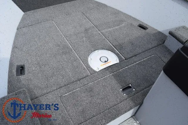 Slide: The Image of 2025 Lund 1600 Fury SS boat interior with carpeted deck and storage compartments. - 14