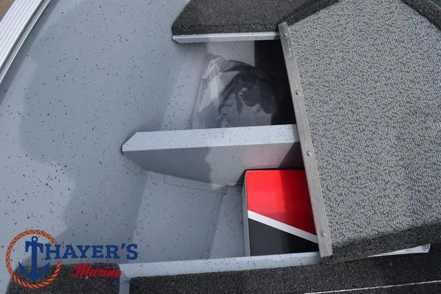 Slide: The Image of 2025 Lund 1600 Fury SS boat storage compartment with carpeted interior. - 15