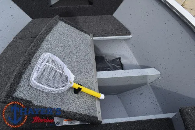 Slide: The Image of 2025 Lund 1600 Fury SS boat interior with storage compartment and fishing net. - 16