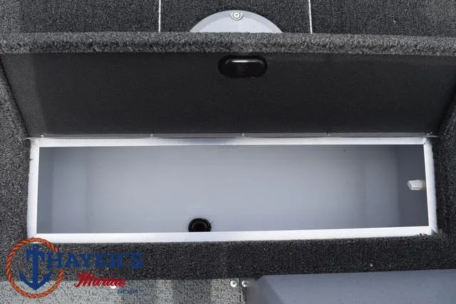 Slide: The Image of 2025 Lund 1600 Fury SS boat storage compartment, open and empty, with gray interior. - 17
