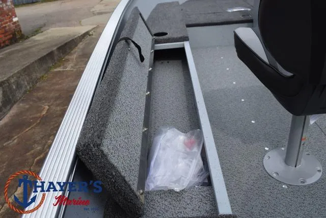 Slide: The Image of 2025 Lund 1600 Fury SS boat interior with storage compartment and seating. - 20
