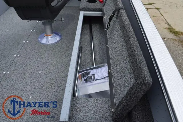 Slide: The Image of 2025 Lund 1600 Fury SS boat interior with storage compartment open, Thayer's Marine logo visible. - 21