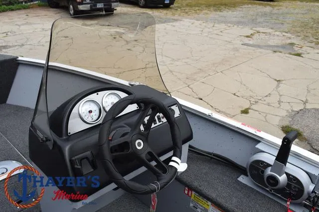 Slide: The Image of 2025 Lund 1600 Fury SS boat dashboard with steering wheel and gauges. - 23