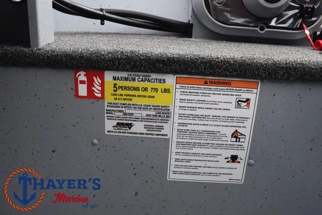 Slide: The Image of 2025 Lund 1600 Fury SS boat capacity and safety warning labels. - 24