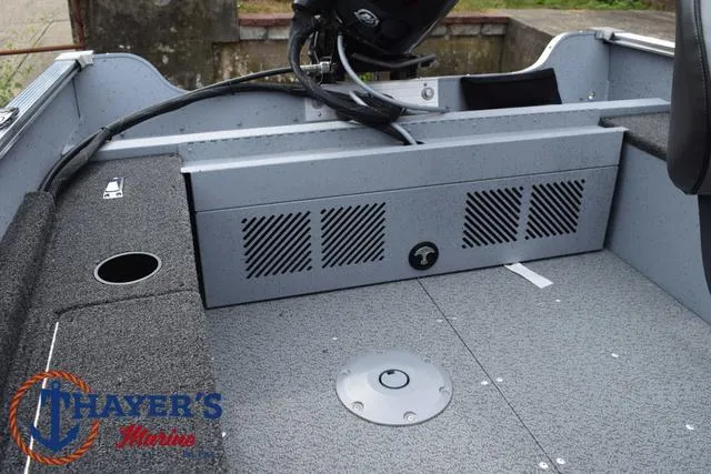 Slide: The Image of 2025 Lund 1600 Fury SS boat interior with storage compartments and Thayer's Marine logo. - 26