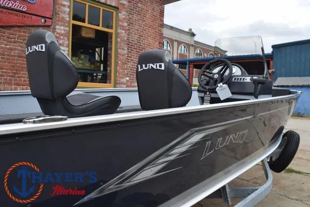 Slide: The Image of 2025 Lund 1600 Fury SS boat with sleek design, parked near a brick building. - 29