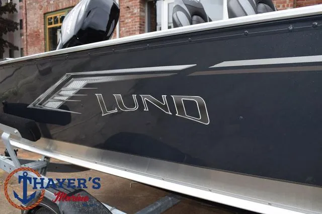 Slide: The Image of 2025 Lund 1600 Fury SS boat side view with logo, displayed at Thayer's Marine. - 30