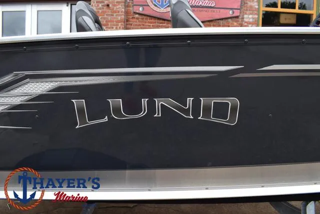 Slide: The Image of 2025 Lund 1600 Fury SS boat side view with Thayer's Marine logo. - 4