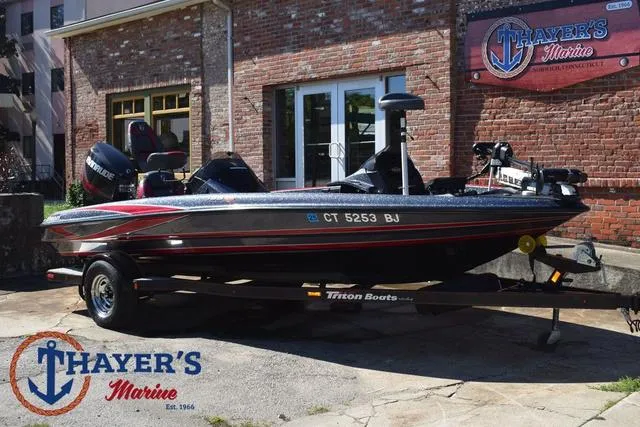 Slide: The Image of 2015 Triton 189 TRX boat at Thayer's Marine dealership, parked outdoors. - 1