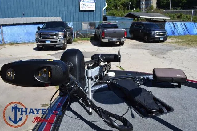 Slide: The Image of 2015 Triton 189 TRX boat with Minn Kota trolling motor in a parking lot. - 13