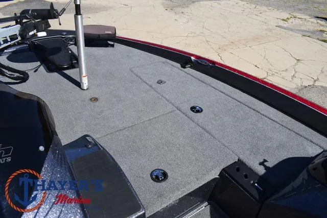 Slide: The Image of 2015 Triton 189 TRX boat deck with storage compartments and fishing equipment. - 15