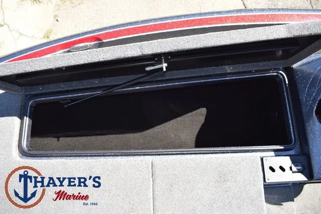 Slide: The Image of Open storage compartment on 2015 Triton 189 TRX boat, Thayer's Marine logo visible. - 16
