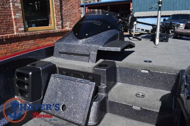 Slide: The Image of 2015 Triton 189 TRX boat deck with storage compartments and fishing equipment. - 18