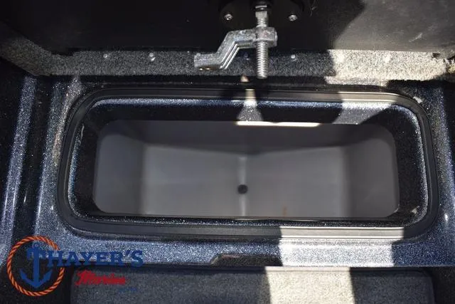 Slide: The Image of 2015 Triton 189 TRX boat storage compartment with latch, interior view. - 20