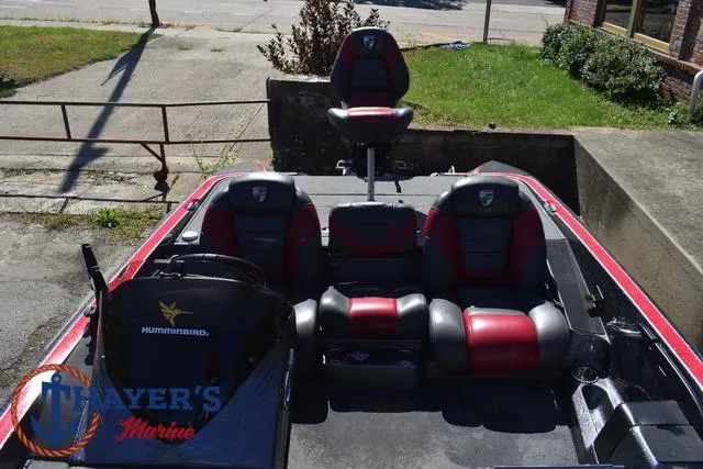 Slide: The Image of 2015 Triton 189 TRX boat interior with red and black seating, featuring a Humminbird system. - 21