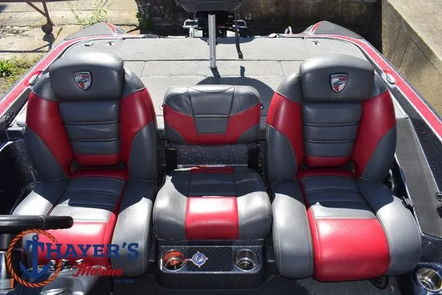Slide: The Image of 2015 Triton 189 TRX boat interior with red and gray seats, Thayer's Marine logo. - 24